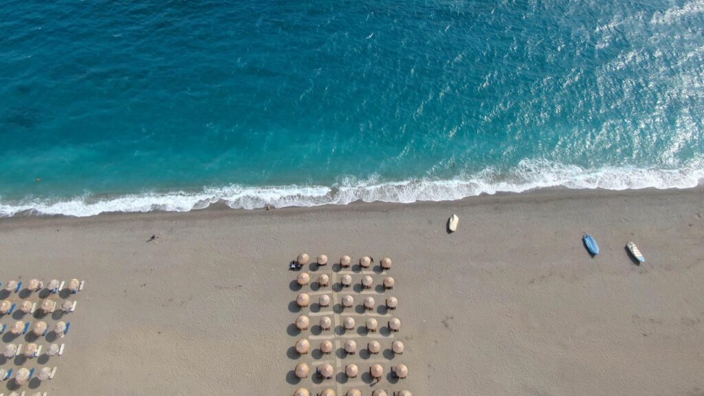 Panoramic view of sandy beach with umbrellas