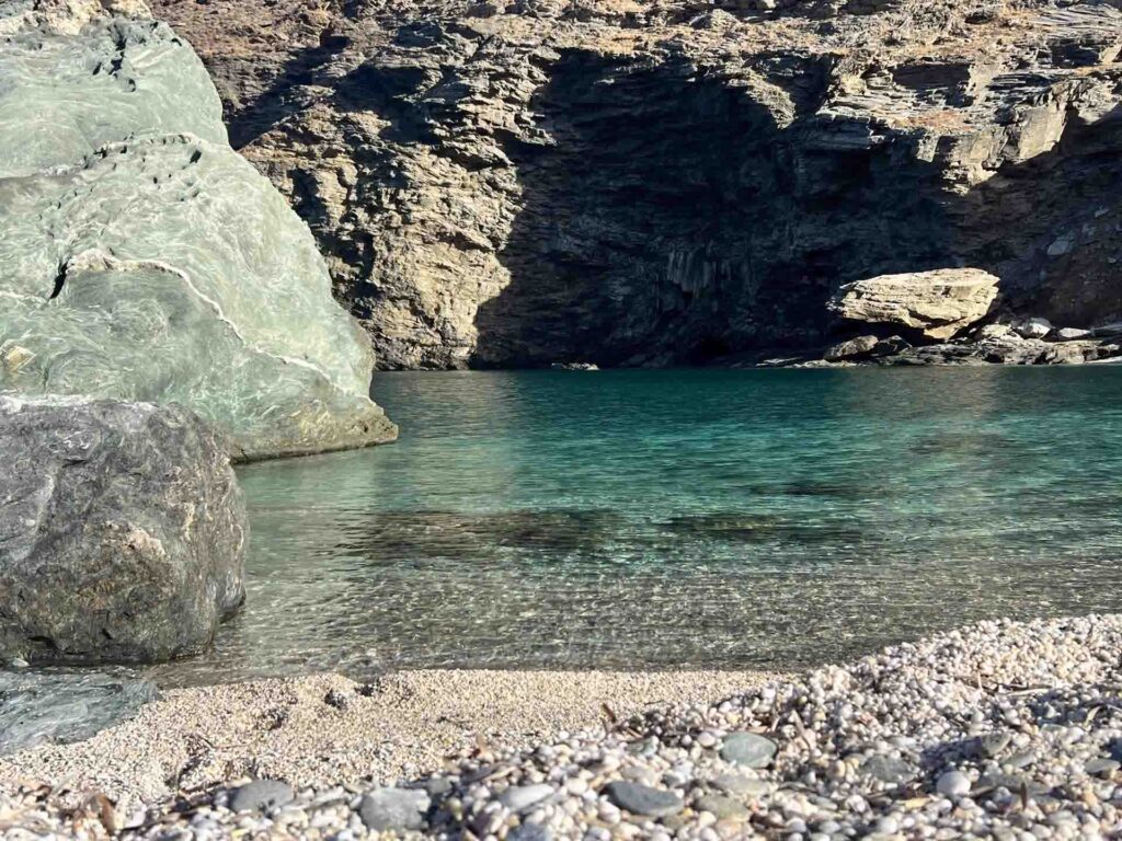 Marble beach with a cave in the background