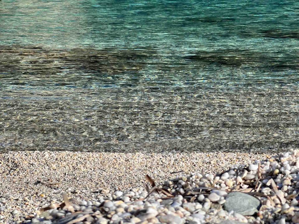 Marbles on the seaside with the sea in the background