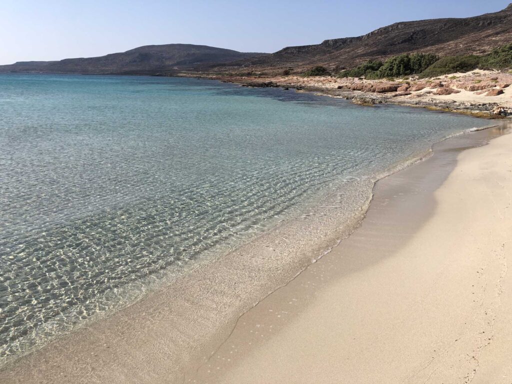 Calm turquoise waters on a sandy Greek beach