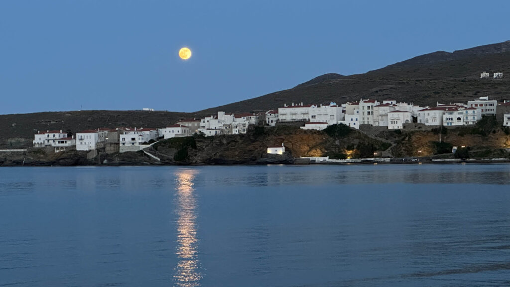 Moon rising over Greek island port