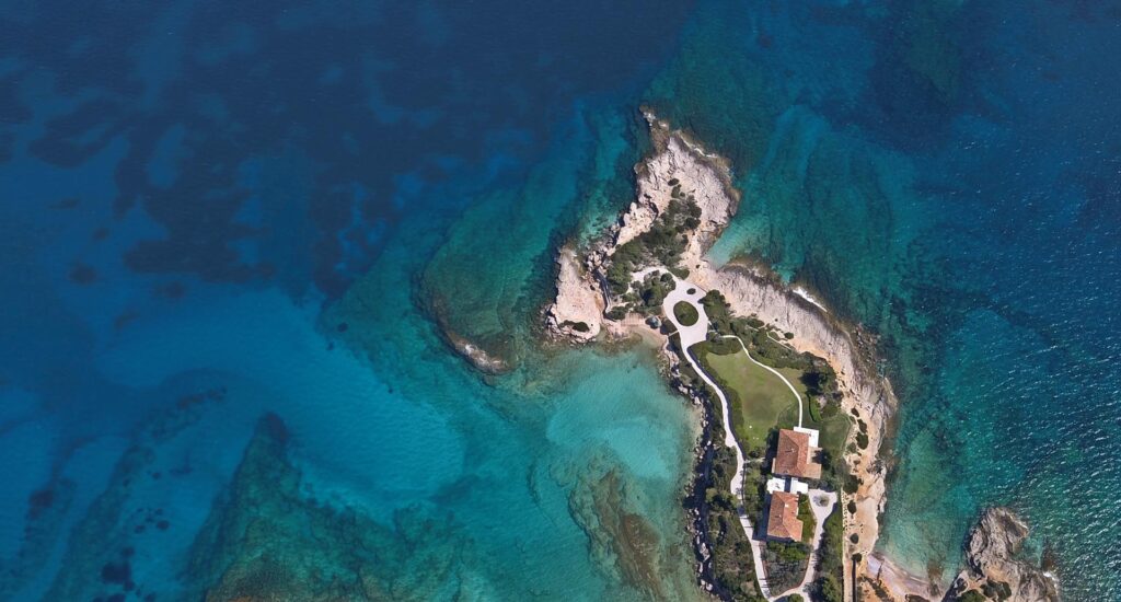 Aerial view of Greek cape in the sea with a residence
