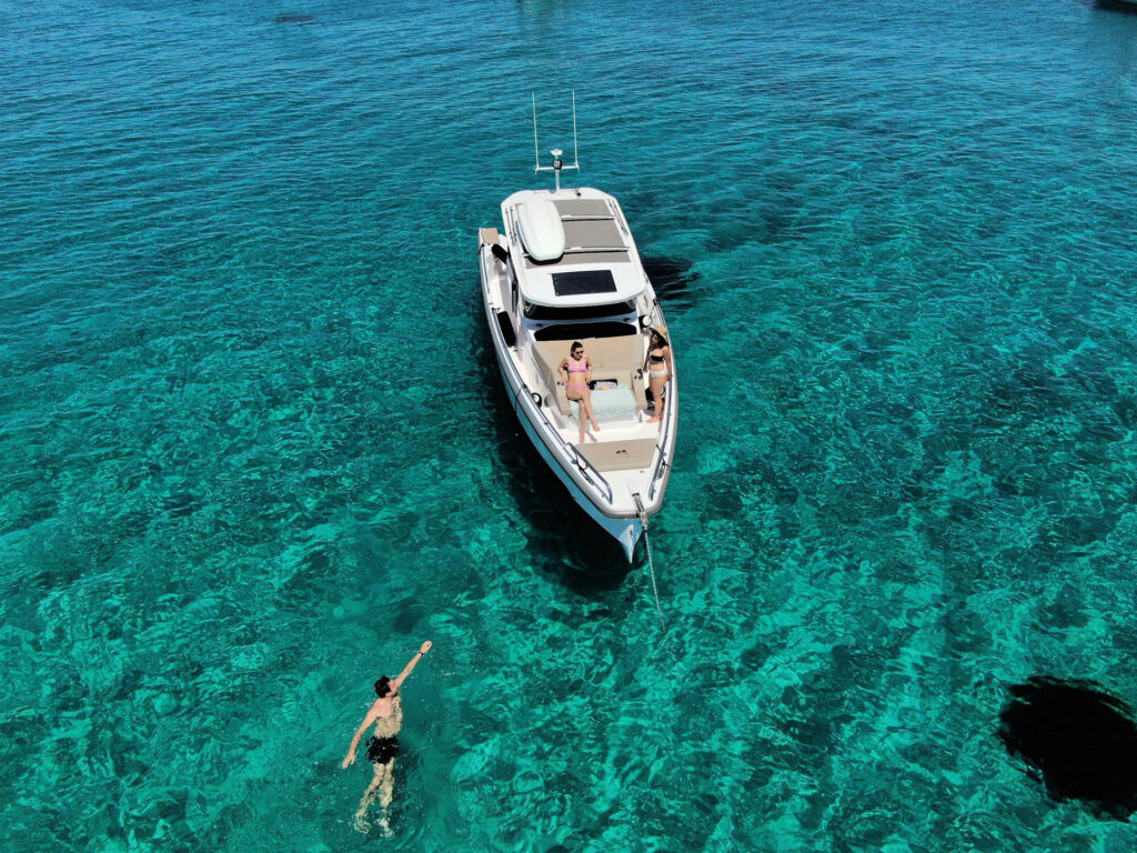 Passengers of the Calypso swimming by the yacht