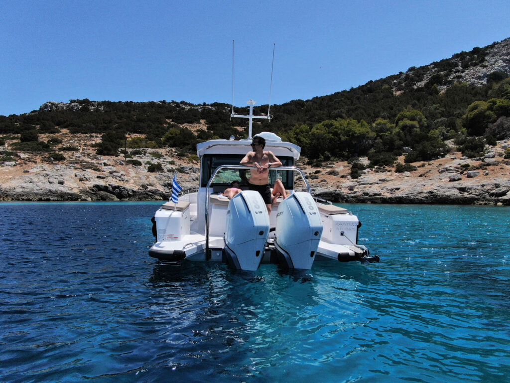 Rear view of the Calypso with passengers and rocky island in the background