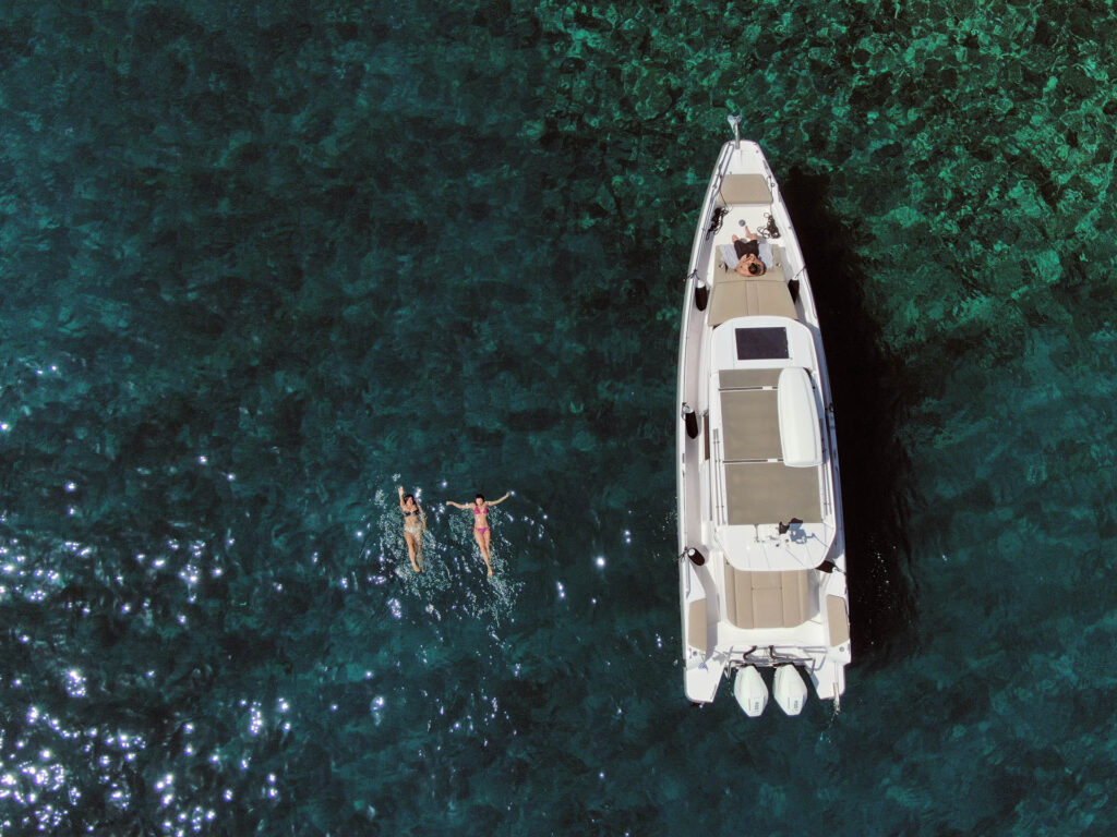 Top view with passengers swimming by the Calypso yacht