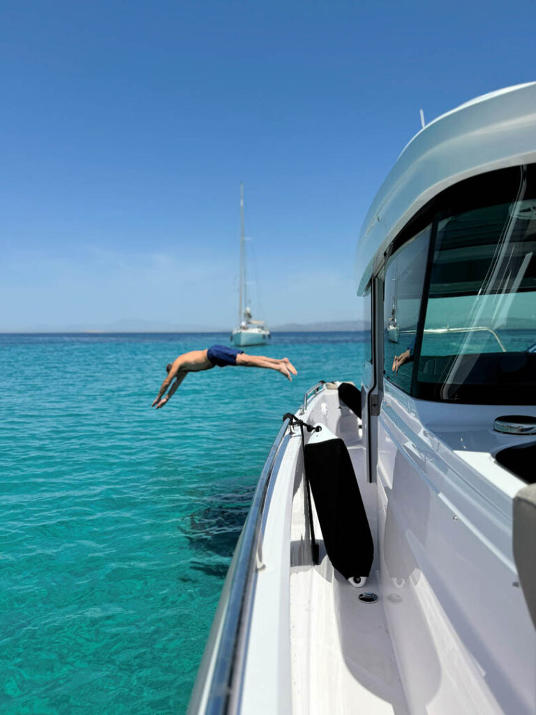 Passenger jump diving from the bow of the Calypso yacht